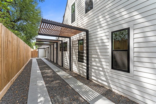 1100 S Shepherd Dr, Houston, TX 77019 - view of property exterior with a pergola and an outbuilding