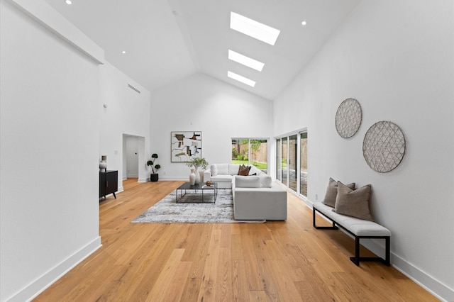 1100 S Shepherd Dr, Houston, TX 77019 - living room featuring a skylight, high vaulted ceiling, and light wood-style flooring
