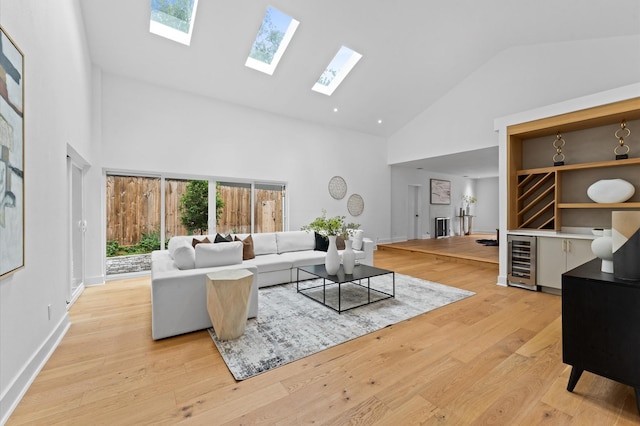 1100 S Shepherd Dr, Houston, TX 77019 - living area with high vaulted ceiling, beverage cooler, a skylight, and light wood-type flooring