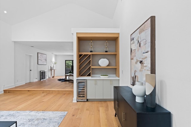 1100 S Shepherd Dr, Houston, TX 77019 - bar featuring wine cooler, light wood finished floors, and vaulted ceiling