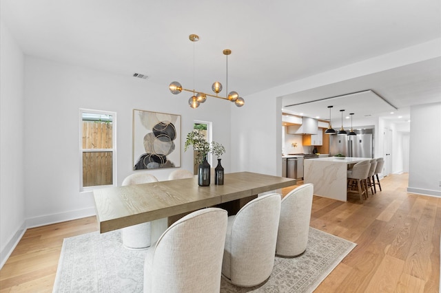 1100 S Shepherd Dr, Houston, TX 77019 - dining room featuring light wood-style flooring, a chandelier, and recessed lighting