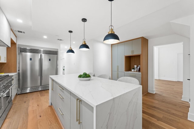 1100 S Shepherd Dr, Houston, TX 77019 - kitchen featuring high end appliances, a kitchen island, recessed lighting, light wood-style floors, and decorative light fixtures