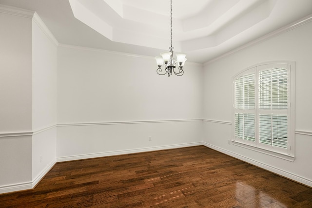 144 Park Way, Montgomery, TX 77356 - empty room featuring a tray ceiling, wood finished floors, a chandelier, baseboards, and ornamental molding