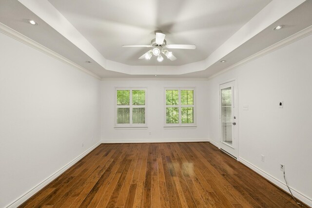 144 Park Way, Montgomery, TX 77356 - unfurnished room featuring a raised ceiling, hardwood / wood-style floors, ceiling fan, and baseboards