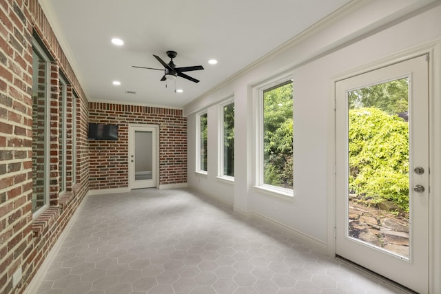 144 Park Way, Montgomery, TX 77356 - unfurnished sunroom featuring brick wall, crown molding, recessed lighting, tile patterned flooring, and baseboards