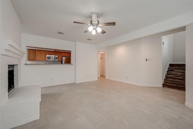 12419 Truesdell Dr, Houston, TX 77071 - unfurnished living room with ceiling fan, a fireplace, stairway, and arched walkways
