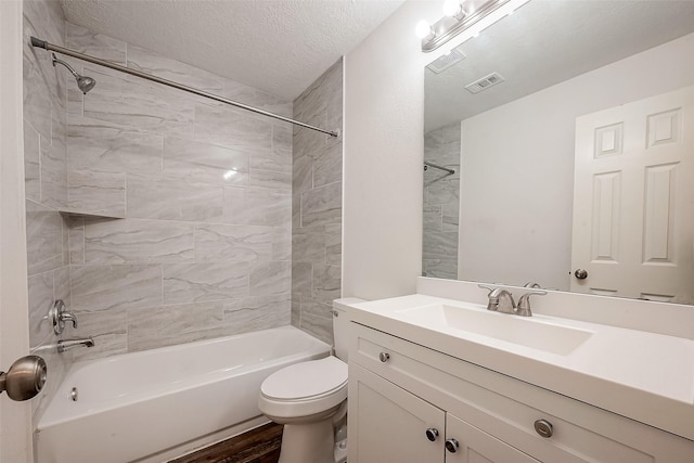 12419 Truesdell Dr, Houston, TX 77071 - full bathroom with bathtub / shower combination, vanity, toilet, wood finished floors, and a textured ceiling