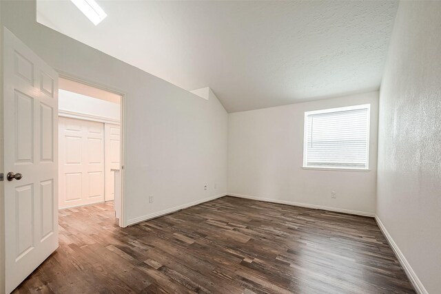 12419 Truesdell Dr, Houston, TX 77071 - additional living space with dark wood-type flooring, baseboards, and vaulted ceiling