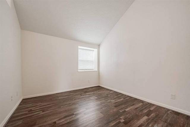 12419 Truesdell Dr, Houston, TX 77071 - empty room with dark wood-style flooring, baseboards, lofted ceiling, and a textured ceiling