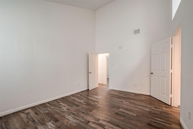 12419 Truesdell Dr, Houston, TX 77071 - spare room with a high ceiling, dark wood finished floors, and baseboards
