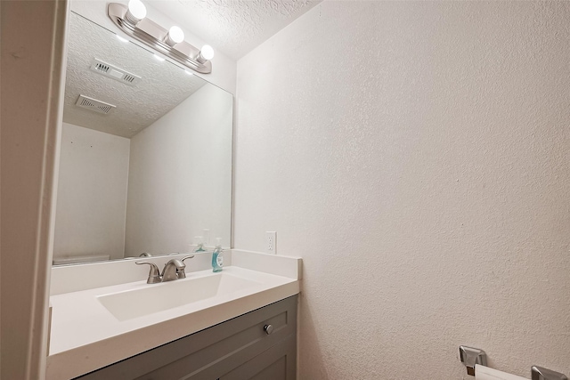 12419 Truesdell Dr, Houston, TX 77071 - bathroom featuring a textured ceiling, vanity, and a textured wall