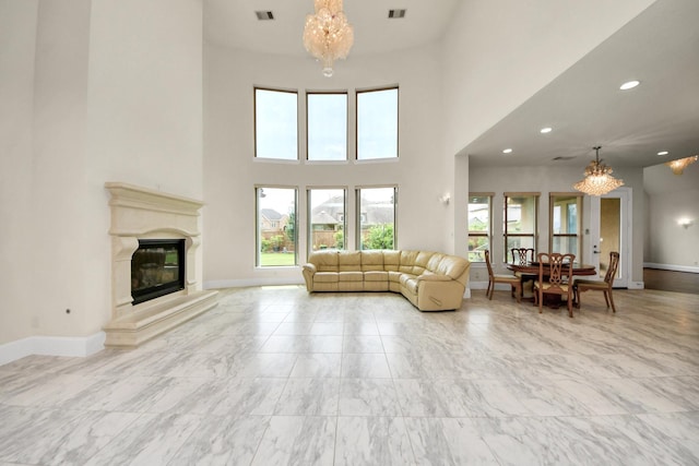 18111 Dockside Landing Dr, Cypress, TX 77433 - living room with a chandelier, marble finish flooring, a high ceiling, baseboards, and recessed lighting