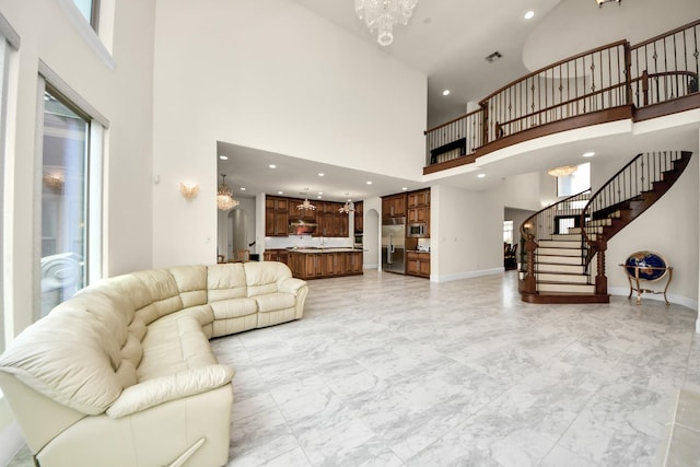 18111 Dockside Landing Dr, Cypress, TX 77433 - living area with a chandelier, a towering ceiling, light marble finish flooring, stairway, and recessed lighting