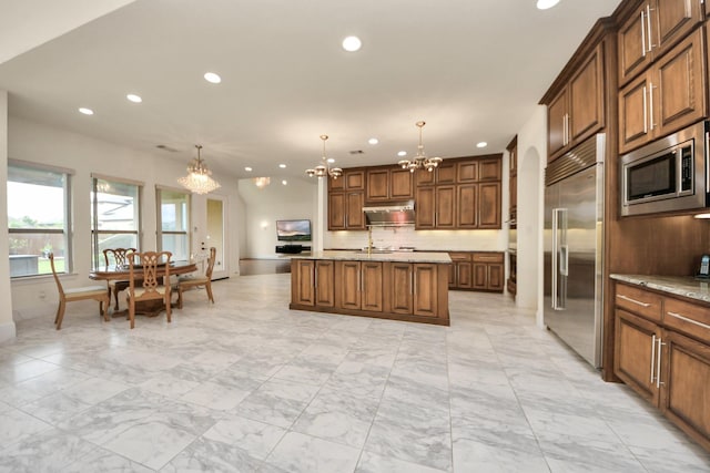 18111 Dockside Landing Dr, Cypress, TX 77433 - kitchen with a chandelier, built in appliances, light marble finish floors, recessed lighting, and decorative backsplash