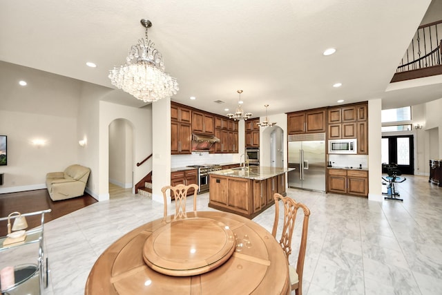 18111 Dockside Landing Dr, Cypress, TX 77433 - dining area featuring a chandelier, arched walkways, stairs, baseboards, and recessed lighting