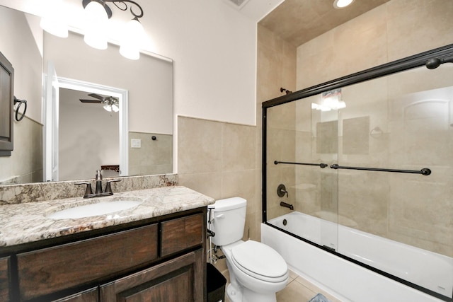 18111 Dockside Landing Dr, Cypress, TX 77433 - bathroom with a ceiling fan, vanity, tile walls, toilet, and bath / shower combo with glass door