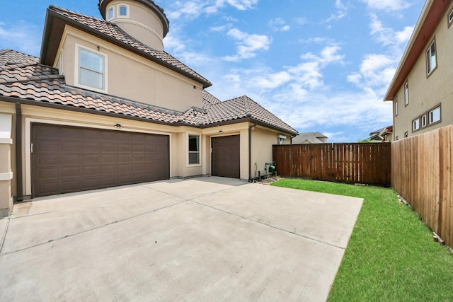 18111 Dockside Landing Dr, Cypress, TX 77433 - view of front of home featuring a tile roof, stucco siding, concrete driveway, and an attached garage