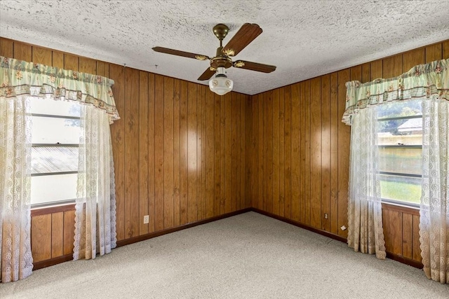 12322 Kitty Ln, Houston, TX 77015 - carpeted empty room with ceiling fan, wood walls, and a textured ceiling