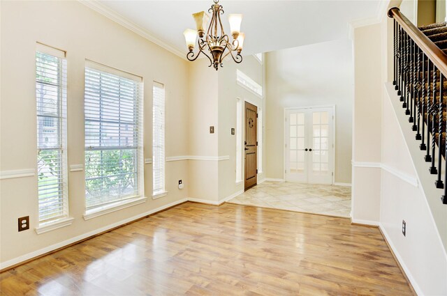 5208 Jolie Dr, Pearland, TX 77584 - foyer entrance featuring stairway, healthy amount of natural light, a chandelier, light wood-style floors, and ornamental molding