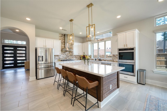 17107 Nulakeast Ct, Houston, TX 77044 - kitchen with appliances with stainless steel finishes, wall chimney exhaust hood, a sink, backsplash, and recessed lighting