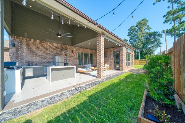17107 Nulakeast Ct, Houston, TX 77044 - rear view of house with brick siding, a ceiling fan, and a patio area