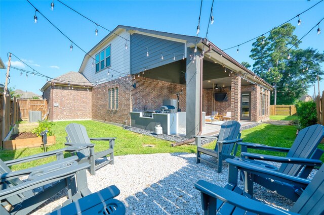 17107 Nulakeast Ct, Houston, TX 77044 - rear view of house with brick siding, an outdoor kitchen, a patio area, and central AC unit