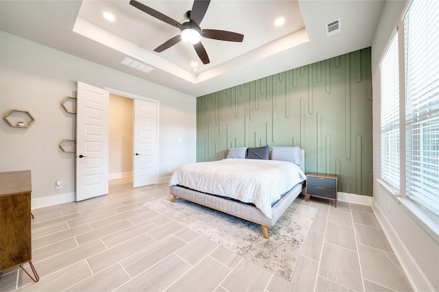 17107 Nulakeast Ct, Houston, TX 77044 - bedroom featuring a raised ceiling, multiple windows, baseboards, recessed lighting, and a ceiling fan
