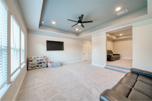 17107 Nulakeast Ct, Houston, TX 77044 - unfurnished living room with a raised ceiling, carpet floors, ceiling fan, baseboards, and recessed lighting