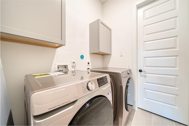 17107 Nulakeast Ct, Houston, TX 77044 - washroom with cabinet space, washing machine and dryer, and light tile patterned floors