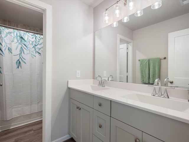 9715 Migrant Hawker Ct, Conroe, TX 77385 - full bath featuring double vanity, wood finished floors, baseboards, and a shower with shower curtain