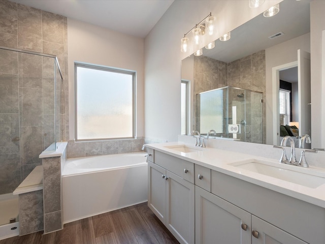 9715 Migrant Hawker Ct, Conroe, TX 77385 - ensuite bathroom featuring a shower stall, double vanity, a garden tub, and wood finished floors