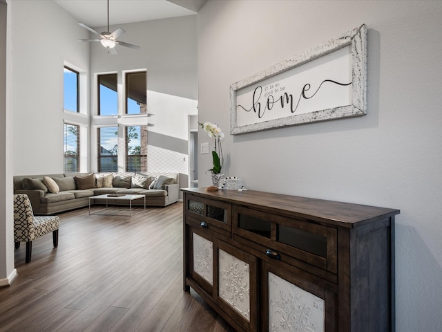 9715 Migrant Hawker Ct, Conroe, TX 77385 - living area with a high ceiling, ceiling fan, and dark wood-style flooring