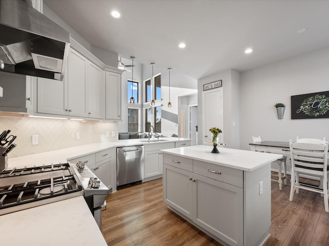 9715 Migrant Hawker Ct, Conroe, TX 77385 - kitchen with appliances with stainless steel finishes, ventilation hood, a sink, backsplash, and a kitchen island