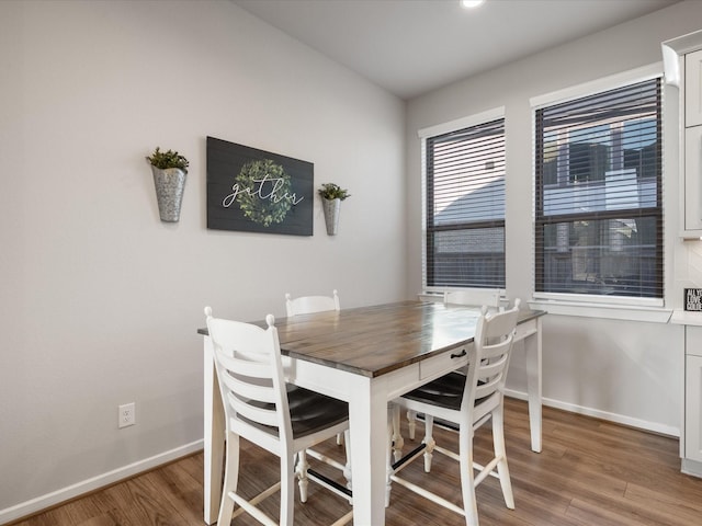 9715 Migrant Hawker Ct, Conroe, TX 77385 - dining room featuring wood finished floors and baseboards
