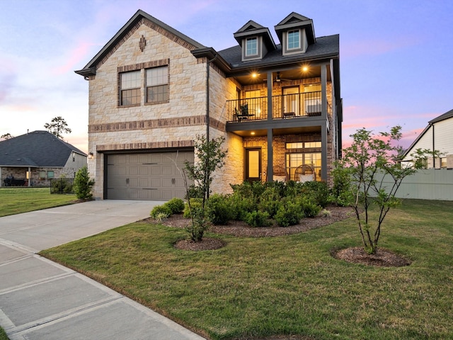 9715 Migrant Hawker Ct, Conroe, TX 77385 - view of front facade featuring a balcony, stone siding, a garage, and driveway