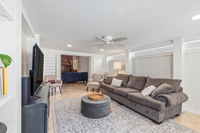 36 Lakeview Dr, Galveston, TX 77551 - tiled living area featuring a ceiling fan, a textured ceiling, brick wall, and recessed lighting