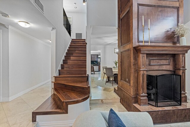36 Lakeview Dr, Galveston, TX 77551 - stairs with ornamental molding, a fireplace, and baseboards