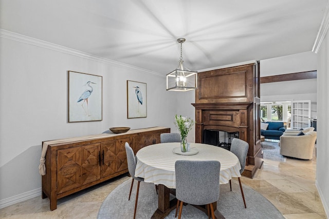 36 Lakeview Dr, Galveston, TX 77551 - dining room with baseboards, ornamental molding, a multi sided fireplace, and light stone finish floors