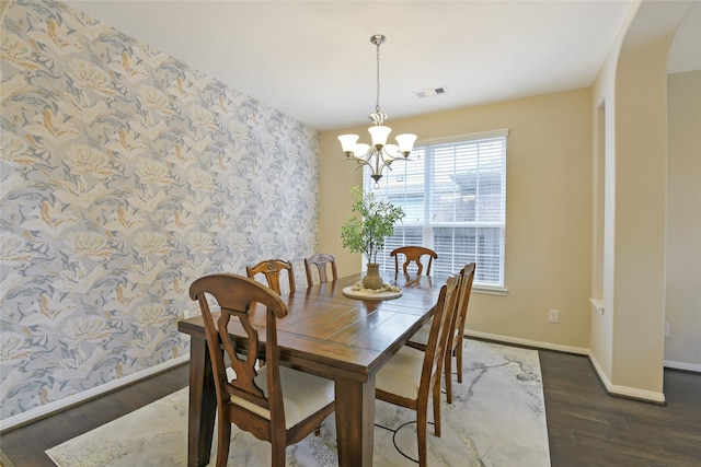 19538 Salt Grass Meadow Dr, Cypress, TX 77433 - dining room with wallpapered walls, a chandelier, baseboards, an accent wall, and wood finished floors