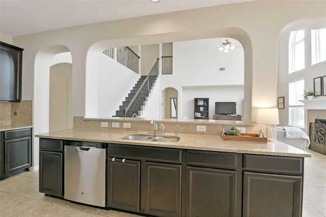 19538 Salt Grass Meadow Dr, Cypress, TX 77433 - kitchen with dishwasher, a sink, open floor plan, arched walkways, and a high ceiling