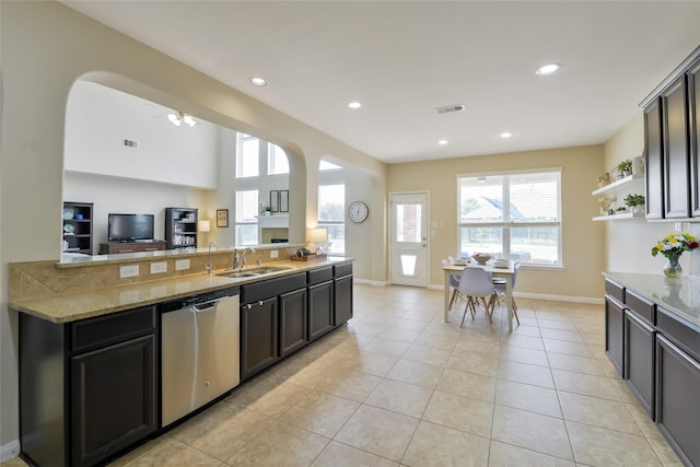 19538 Salt Grass Meadow Dr, Cypress, TX 77433 - kitchen featuring stainless steel dishwasher, a sink, light stone countertops, baseboards, and recessed lighting