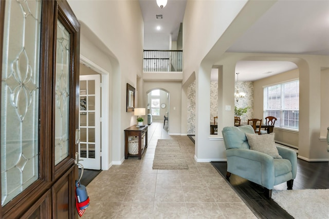 19538 Salt Grass Meadow Dr, Cypress, TX 77433 - foyer with arched walkways, healthy amount of natural light, and baseboards