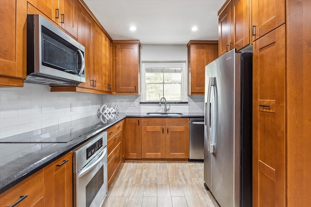 811 Lovett Blvd Unit 26, Houston, TX 77006 - kitchen featuring stainless steel appliances, brown cabinets, and recessed lighting