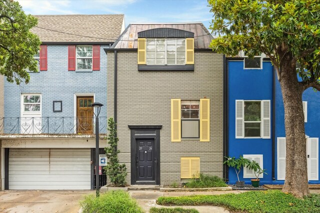 811 Lovett Blvd Unit 26, Houston, TX 77006 - view of front of home with a garage, brick siding, and concrete driveway