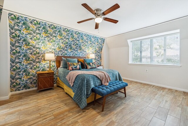 811 Lovett Blvd Unit 26, Houston, TX 77006 - bedroom with wallpapered walls, light wood-style flooring, and a ceiling fan