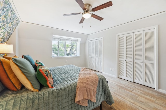 811 Lovett Blvd Unit 26, Houston, TX 77006 - bedroom featuring two closets, wood finished floors, and a ceiling fan