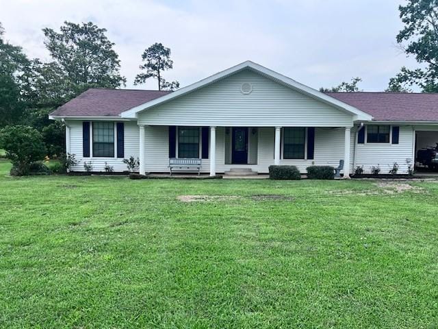 8594 Morgan Ln, Orange, TX 77632 - ranch-style house featuring a front lawn and a porch