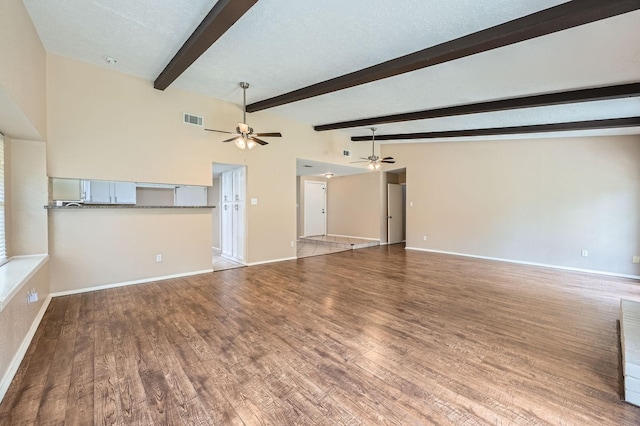 9519 Landry Blvd, Spring, TX 77379 - unfurnished living room featuring a ceiling fan, wood finished floors, baseboards, and beam ceiling