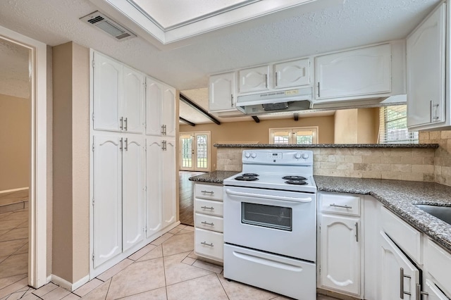 9519 Landry Blvd, Spring, TX 77379 - kitchen featuring white electric stove, under cabinet range hood, white cabinets, and tasteful backsplash