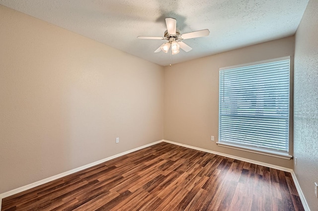 9519 Landry Blvd, Spring, TX 77379 - unfurnished room featuring dark wood-style floors, ceiling fan, baseboards, and a textured ceiling